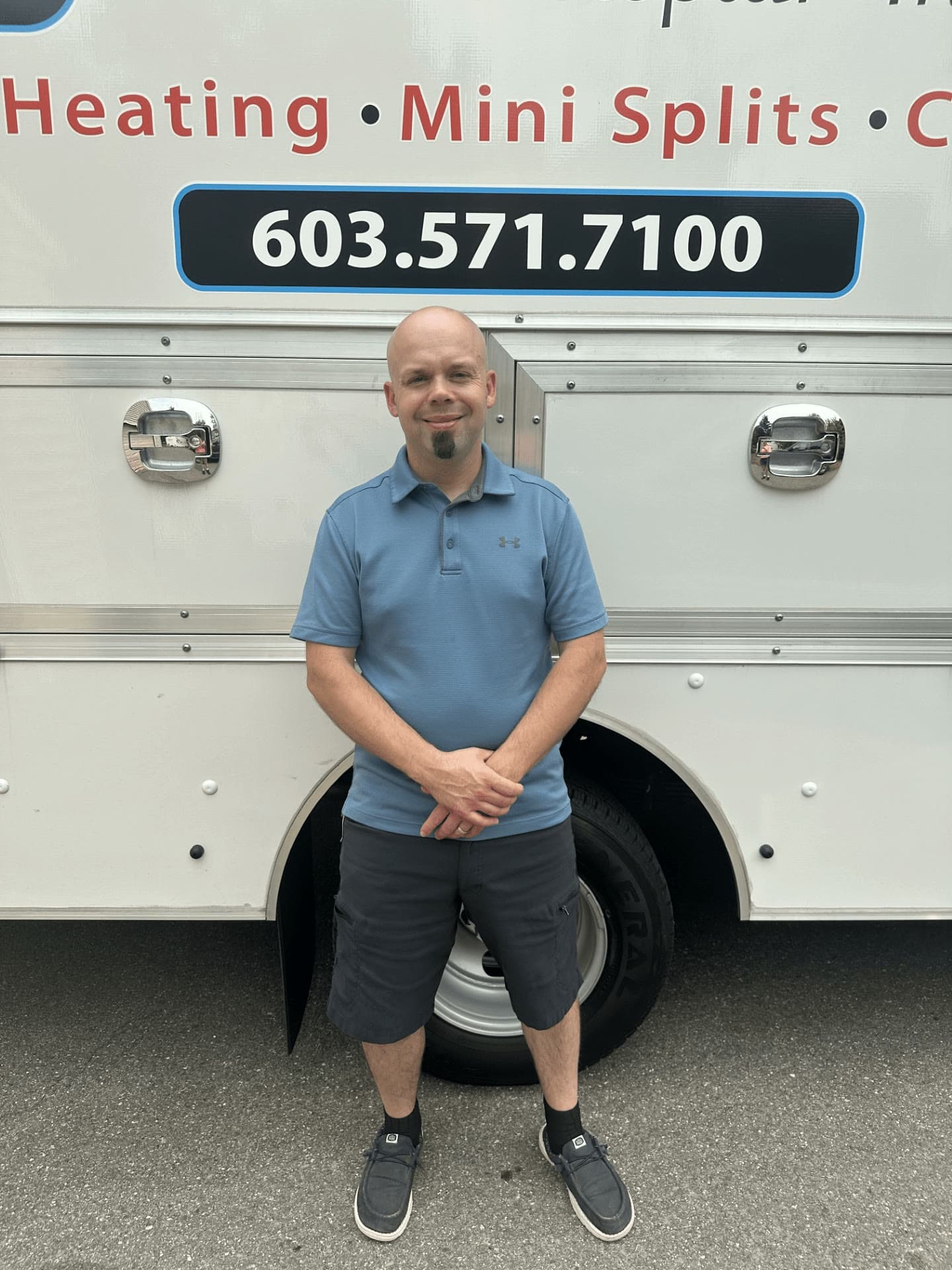 Brian Chesney standing in front of the lettered Southern New Hampshire HVAC Services box truck.
