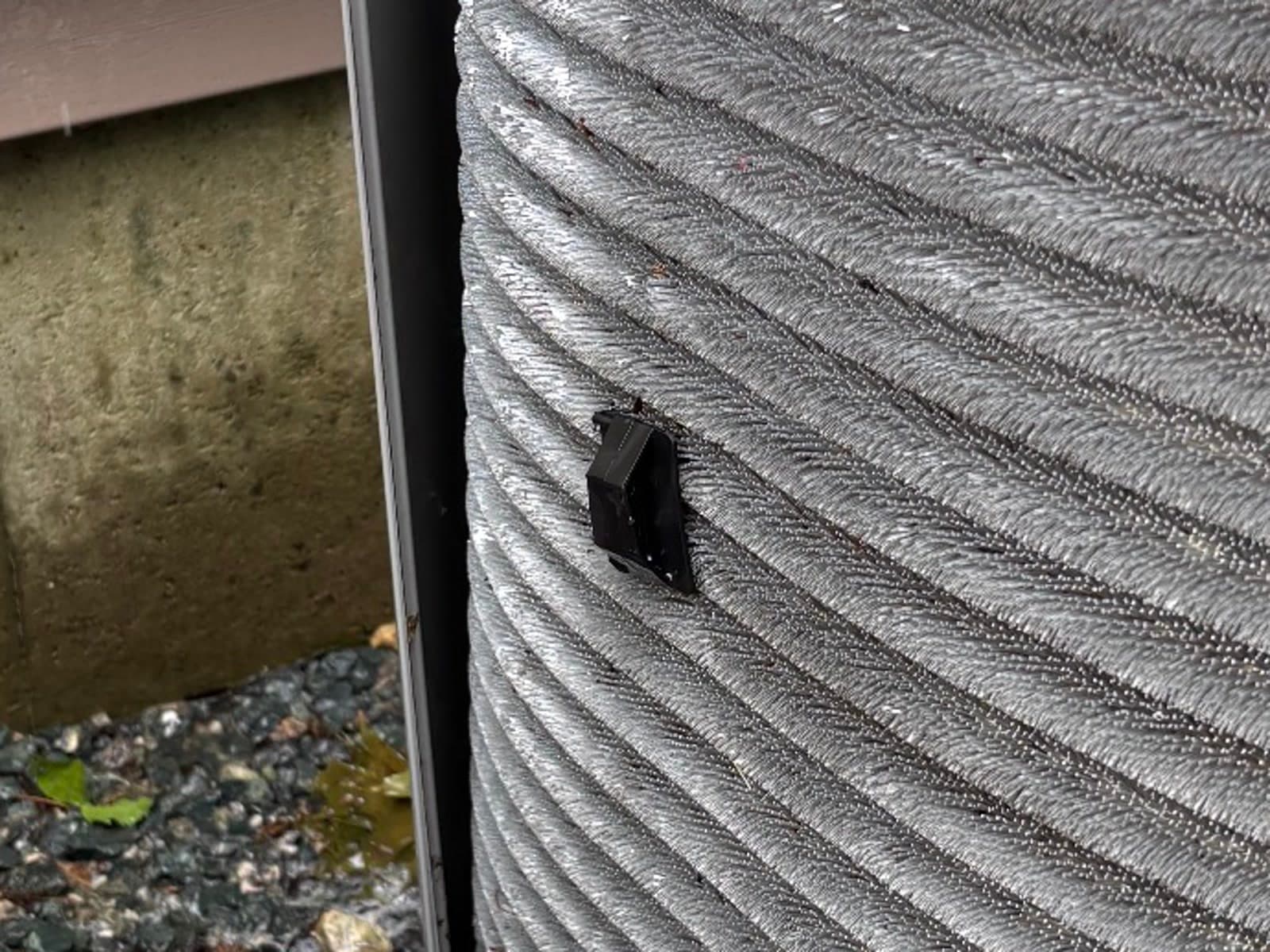 The same outdoor condenser coil after cleaning, fins clear and straight with the metal visible