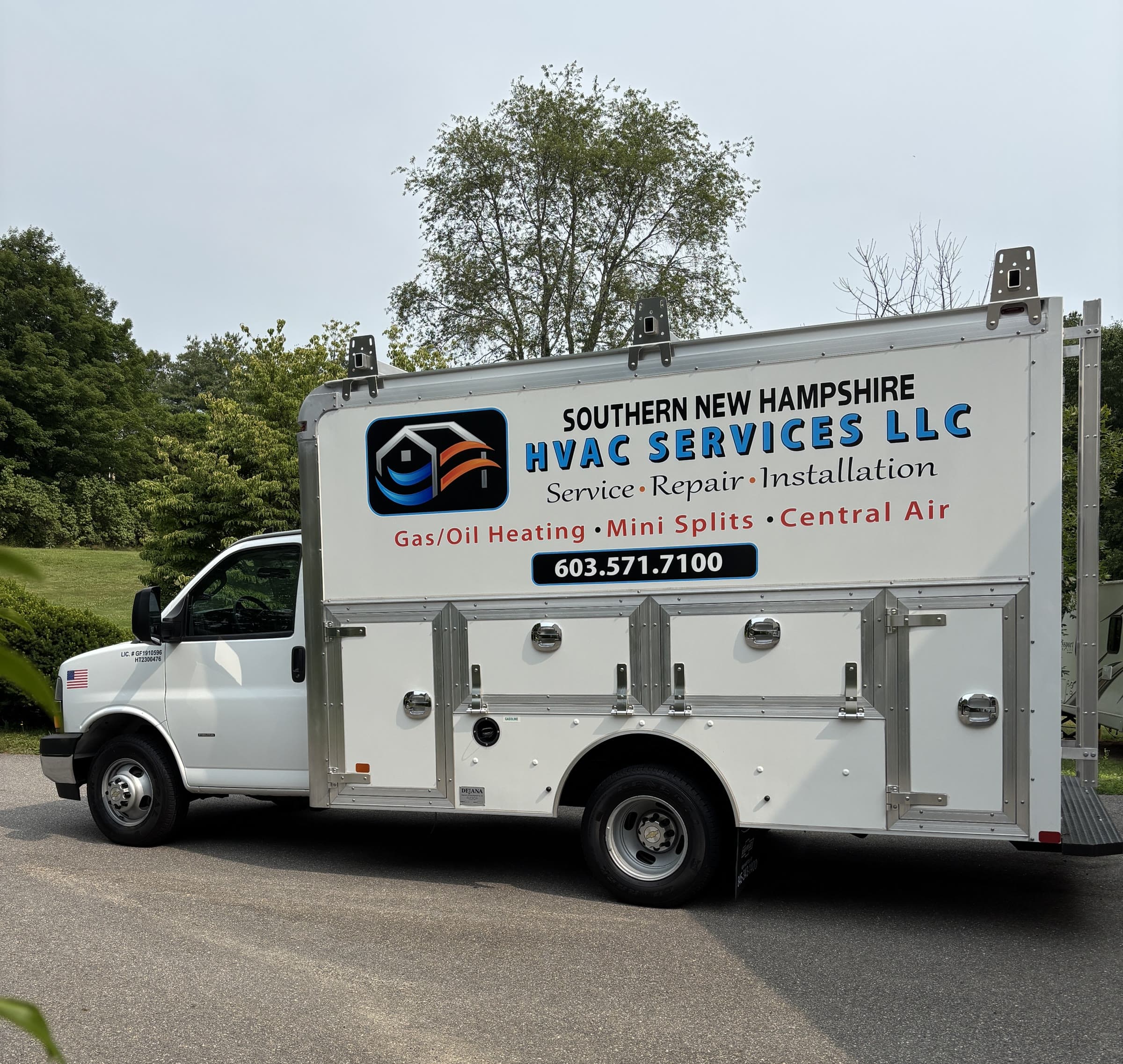 The Southern New Hampshire HVAC Services box truck parked in a New Hampshire driveway, with the gas and oil license numbers lettered on the cab door